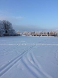 Snow covered field against sky