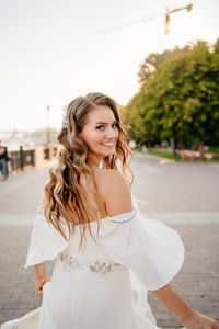 Portrait of smiling young woman standing outdoors