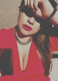 Close-up of woman sitting on wall