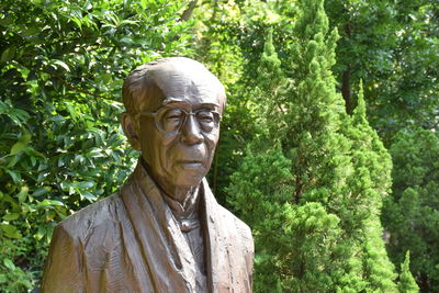 Statue against trees in park