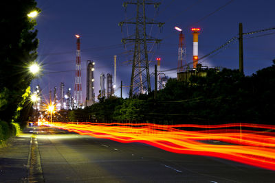 Light trails of taillights in factory areas.