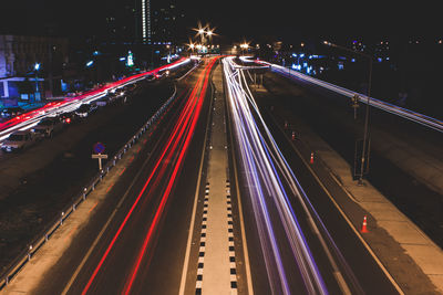 High angle view of light trails on highway at night