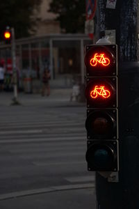 Illuminated road sign on city street