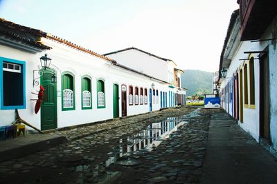 Empty alley along buildings