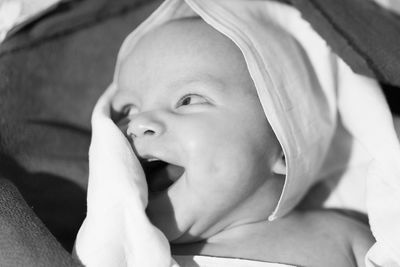 Close-up of cute baby boy on bed