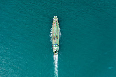 Aerial top view oil ship tanker full speed with beautiful wave and splash water in line
