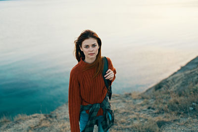 Portrait of smiling young woman standing outdoors