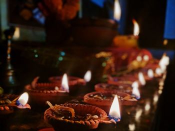 Close-up of lit candles on table