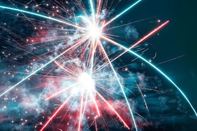 Low angle view of firework display at night