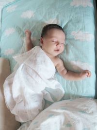 Close-up of baby sleeping on bed