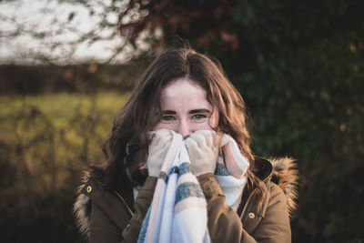 Portrait of woman against plants