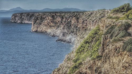 Scenic view of sea with mountains in background