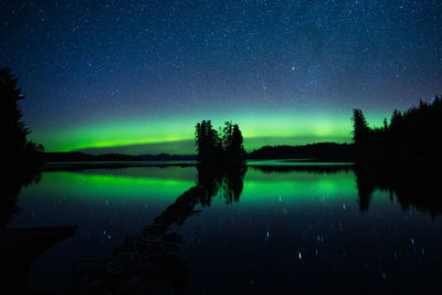 Scenic view of lake against sky with the northern lights