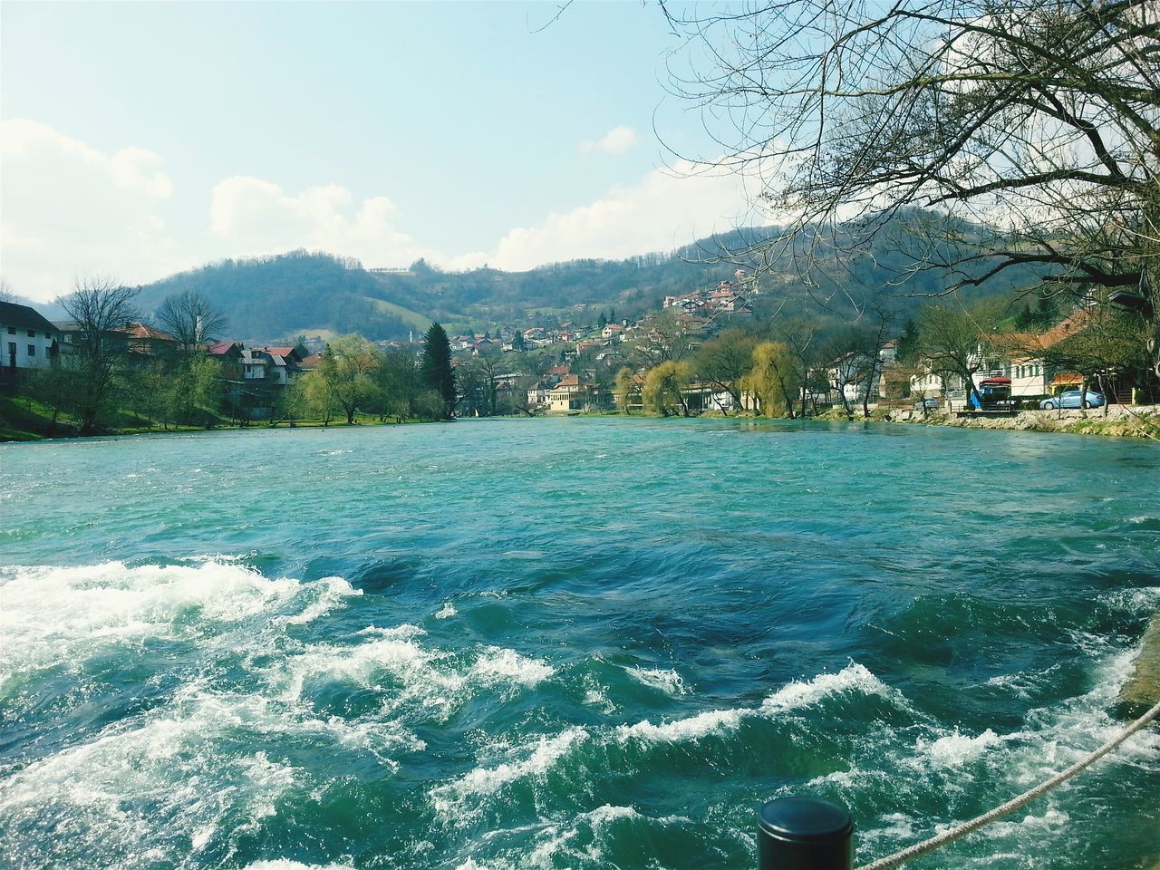 water, mountain, sky, tree, building exterior, architecture, built structure, river, cloud - sky, waterfront, nature, scenics, cloud, mountain range, beauty in nature, house, day, lake, outdoors