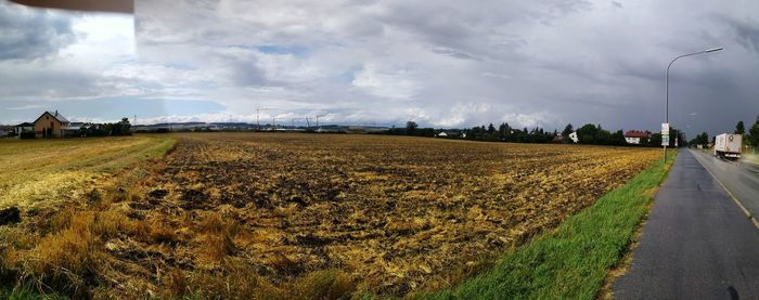 Scenic view of agricultural field against sky