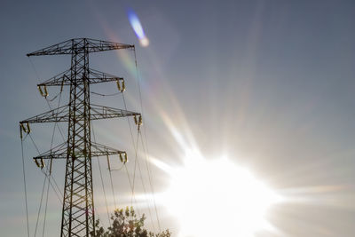 Low angle view of electricity pylon against sky