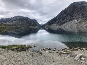 Scenic view of lake amidst mountains against sky