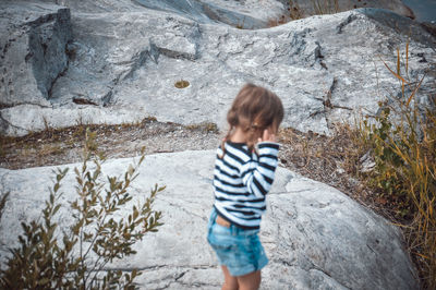 Full length of boy standing on rock