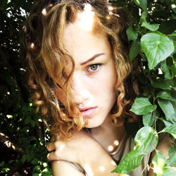 Portrait of young woman amidst plants