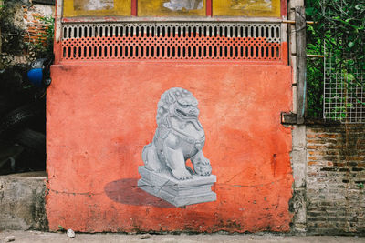 Shadow of statue on wall