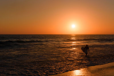 Scenic view of beach against sky during sunset