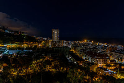 Illuminated buildings in city at night