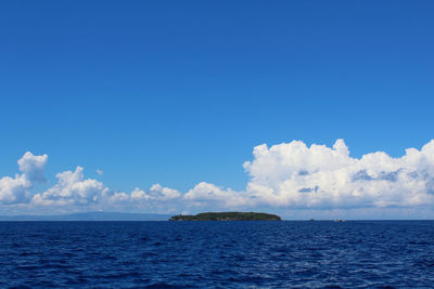 Scenic view of sea against blue sky