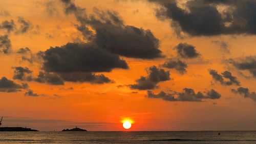 Scenic view of sea against orange sky