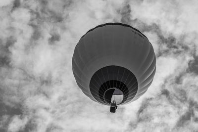 Low angle view of hot air balloon against cloudy sky