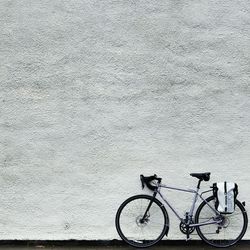 Bicycle parked against wall