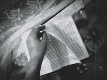 Midsection of woman reading book
