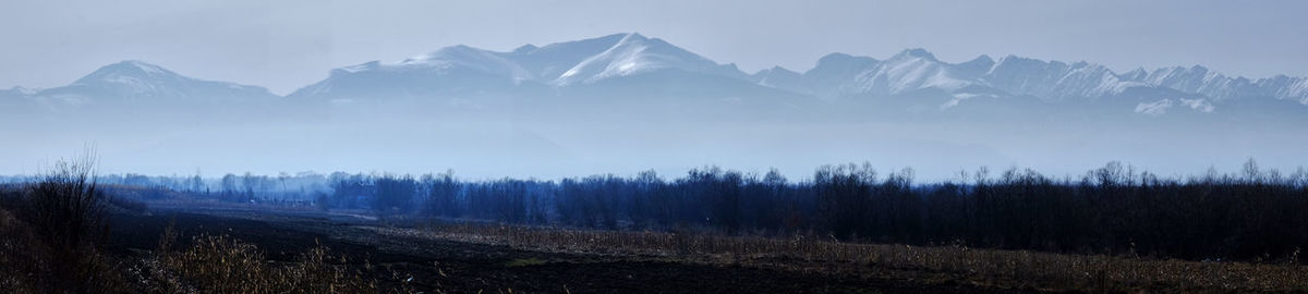 Scenic view of snowcapped mountains against sky