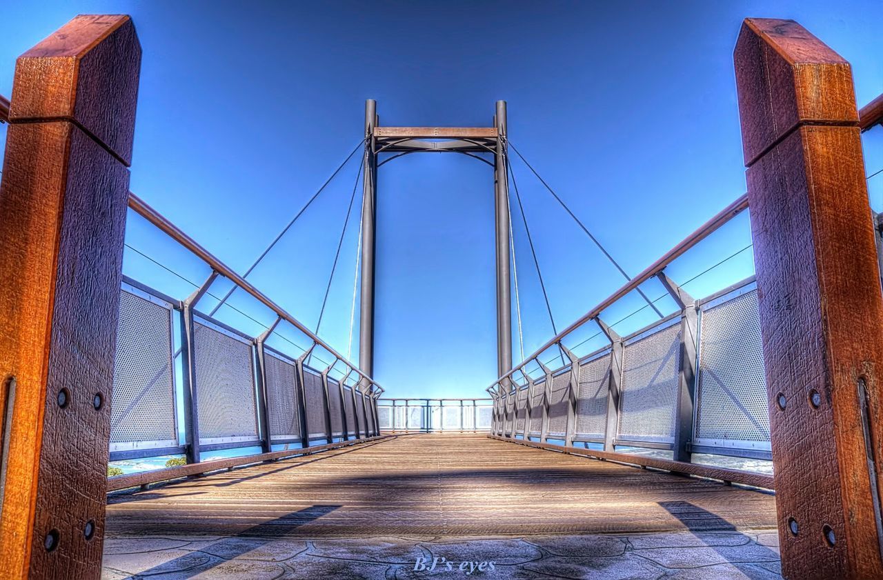 VIEW OF SUSPENSION BRIDGE AGAINST CLEAR SKY