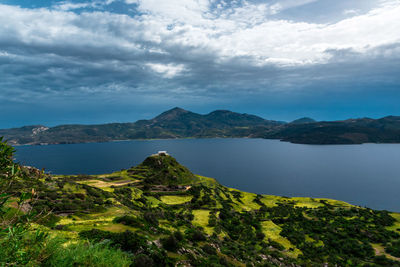 Scenic view of lake and mountains against sky