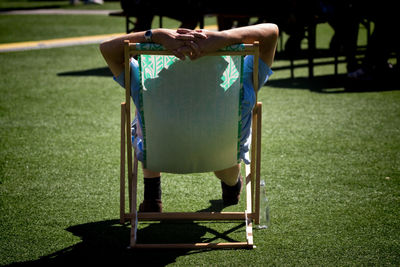 Rear view of man sitting on chair