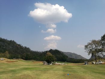 Scenic view of golf course against sky