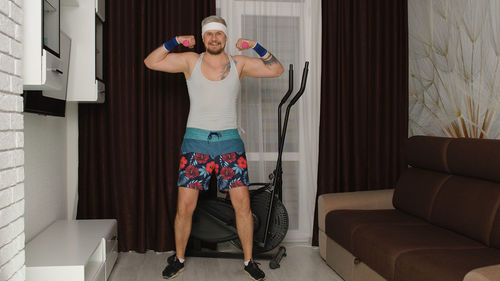 Full length of man exercising at home