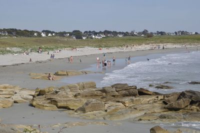 People on beach against sky