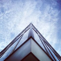 Low angle view of building against cloudy sky