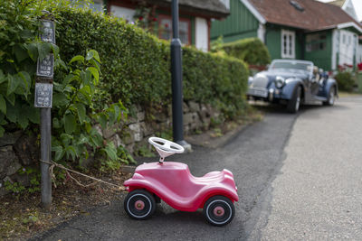 Ride-on car tied up to pole