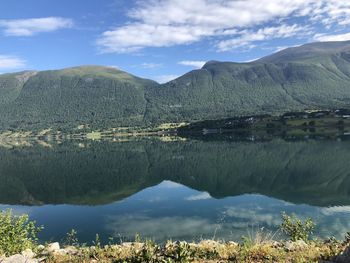 Scenic view of lake and mountains against sky