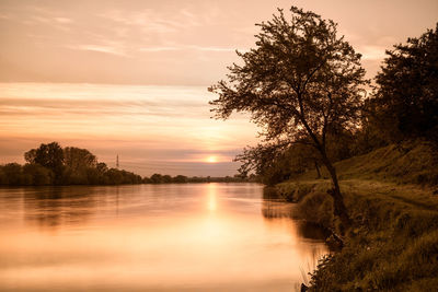 Scenic view of lake against sky during sunset