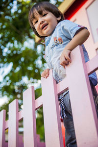 Low angle view of cute girl standing outdoors