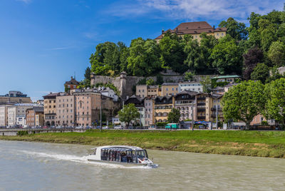 Boat in river against buildings