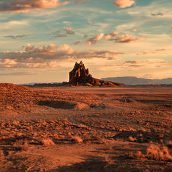 Scenic view of desert against sky during sunset