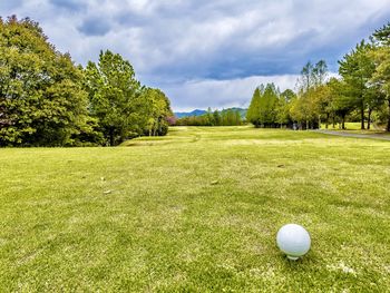 View of golf ball on field against sky