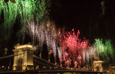 Low angle view of firework display against sky at night