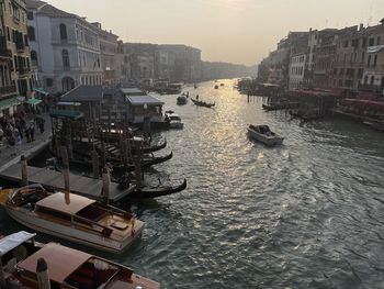 High angle view of boats moored in sea against buildings in city