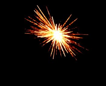 Low angle view of firework display at night