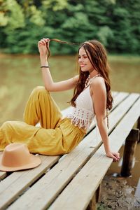 Young woman sitting on wooden floor